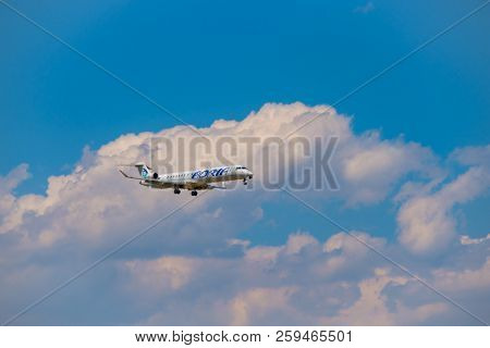 Zurich, Switzerland - July 19, 2018: Adria airlines airplane flying in the blue cloudy sky,  preparing for landing at day time in Zurich nternational airport