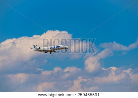 Zurich, Switzerland - July 19, 2018: Adria airlines airplane flying in the blue cloudy sky,  preparing for landing at day time in Zurich nternational airport