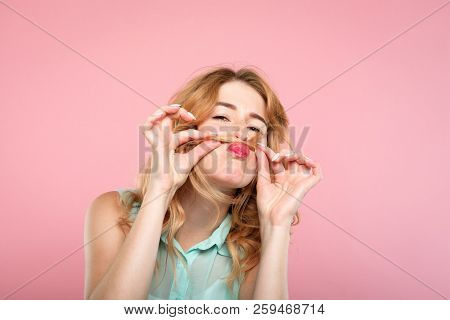 Funny Amusing Laughable Girl Monkeying Around With Her Hair. Portrait Of A Young Carefree Woman Maki