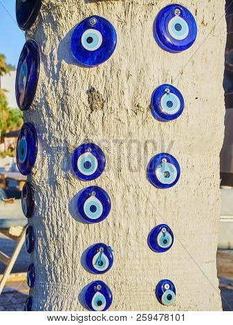 A Lot Of Nazar Boncugu, A Turkish Eye-shaped Amulet Screwed To A Tree. Turkey.