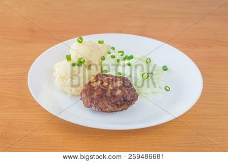 Kotlet Mielony - Polish Variety Of Meatballs With Mizeria, Mashed Potatoes And Chives For Decoration