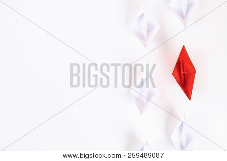 Red Paper Boat Among Other White. Leadership, White Crow, Individuality. Piranhas And A Shark. Not L