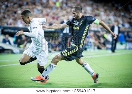 VALENCIA, SPAIN - SETEMBER 19: (L) Rodrigo and Chiellini during UEFA Champions League match between Valencia CF and Juventus at Mestalla Stadium on September 19, 2018 in Valencia, Spain
