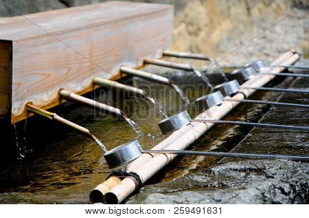 Washing Hands In The Izumo Taisha Shrine In Shimane, Japan. To Pray, Japanese People Usually Clap Th