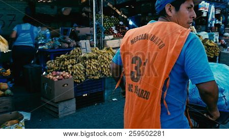 Santa Cruz, Bolivia - Sept 5 2018: Young Man Pushing A Wheelbarrow To Transport Vegetables At The Ci