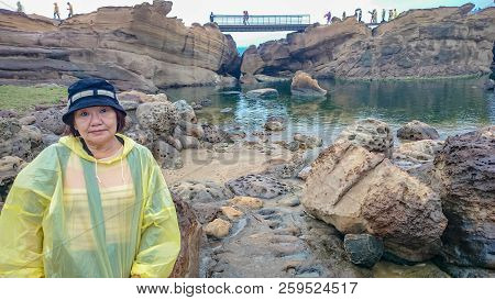 Happy Old Asian Women Wear A Rain Roat And Travel In Taipei Yehliu Geopark In Rainy Day,taiwan Trave