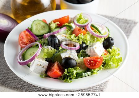Fresh Greek Salad Made Of Cherry Tomato, Ruccola, Arugula, Feta, Olives, Cucumbers, Onion And Spices