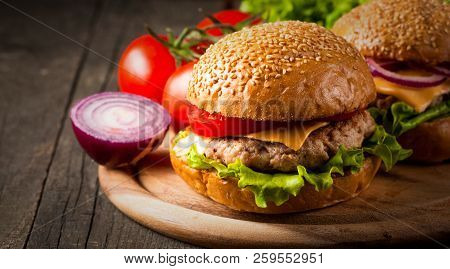 Close-up Photo Of Home Made Hamburger With Beer Made Of Beef, Onion, Tomato, Lettuce, Cheese And Spi