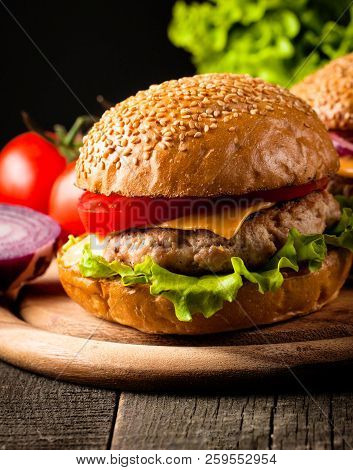 Close-up Photo Of Home Made Hamburger With Beer Made Of Beef, Onion, Tomato, Lettuce, Cheese And Spi