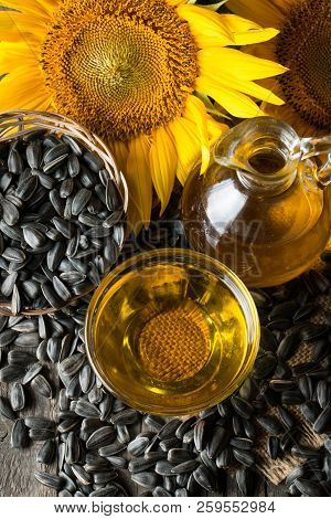 Sunflower Oil And Sunflower Seeds In Small Sack On Traditional Rustic Wooden Background. Organic And