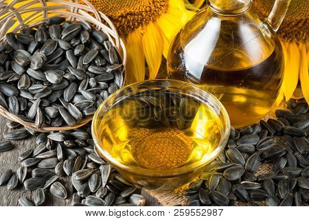 Sunflower Oil And Sunflower Seeds In Small Sack On Traditional Rustic Wooden Background. Organic And