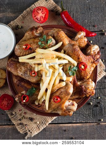 Close-up Photo Of Bbq Chicken Wings With Fries And Beer. Barbeques Meat With Sauces, Ketchup, Mayonn
