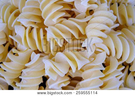 Giant Fusilli Pasta Background. Close Up View.