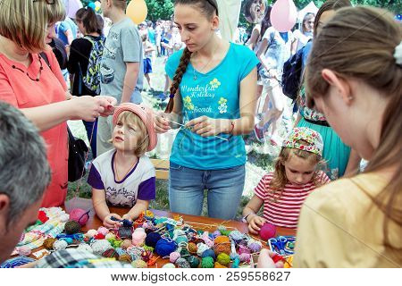 Zaporozhia/ukraine- June 2, 2018: Charity Family Festival-young Woman - Volunteer Explaining To Smal