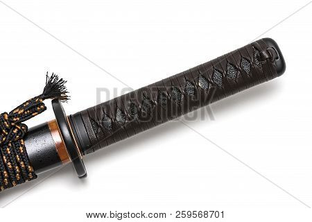 Tsuka: Handle Of Japanese Sword  Isolated In White Background. Black Rayskin And Brown Leather Cord 