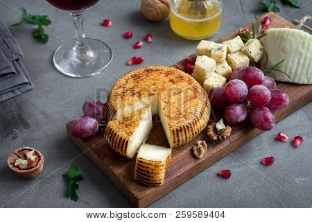Cheese Platter With Assorted Cheeses, Grapes, Nuts On White Background, Copy Space. Italian Cheese A