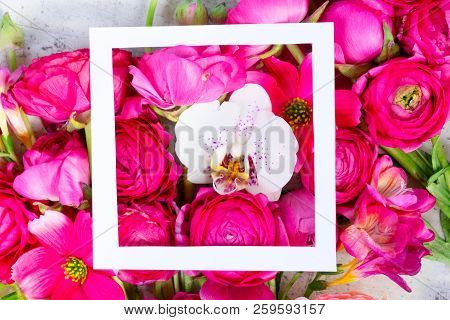 Flowers Composition. Floral Natural Background Made Of Rununculus And Orchid Fresh Flowers With Whit