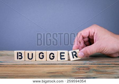 Bugger. Wooden Letters On The Office Desk, Informative And Communication Background