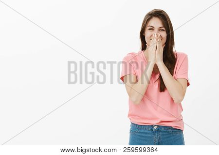 Optimistic Carefree Attractive Woman With Long Brown Hair, Chuckling And Covering Mouth With Palms, 