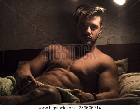 Shirtless Sexy Male Model Lying Alone On His Bed