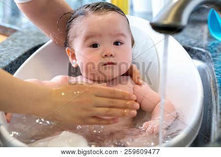 Baby Boy Taking A Bath In A Little Bath Tub
