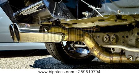 Dual Chrome Exhaust Pipe At The Bottom Of A Car