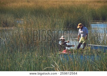 Lake Titicaca, Peru - August 17th, 2018: Two Peruvian Women Who Live On The Floating Reep Islands Ar