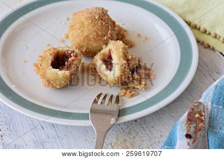 Plum Dumplings Knedle On The White Plate With Lace Napkin On The Wooden Table;