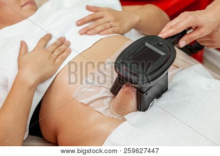 Woman Getting Cryolipolysis Fat Treatment Procedure In Professional Cosmetic Cabinet Or Spa Center