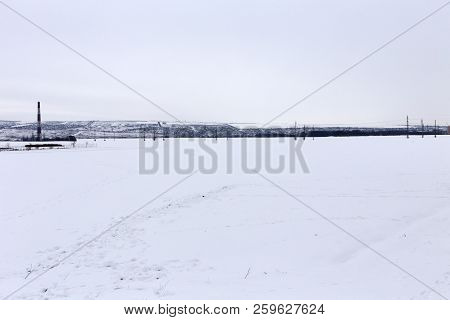 Fresh Snow Blankets A Rural Field Is After A Snow Storm.