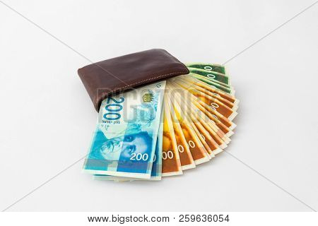 Вrown  Leather Wallet And Stack Of Banknotes New Israeli Shekels Isolated On White Background