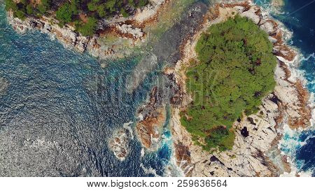 Beautiful View Of The Peninsula And A Small Rocky Island. Seaside Landscape With Coniferous Forest. 