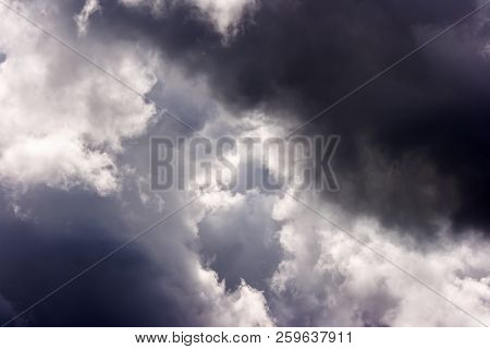 Storm Cloud On Sunny Day. Light In The Dark And Dramatic Storm Clouds. Background Of Storm Clouds Be