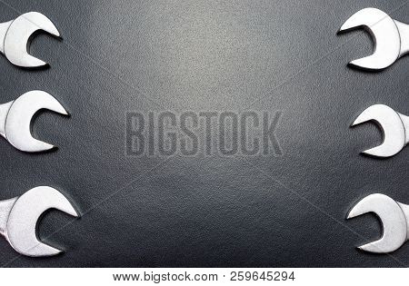 Metal Flat Wrenches Lying On A Black Table, Top View, Flat Lay.