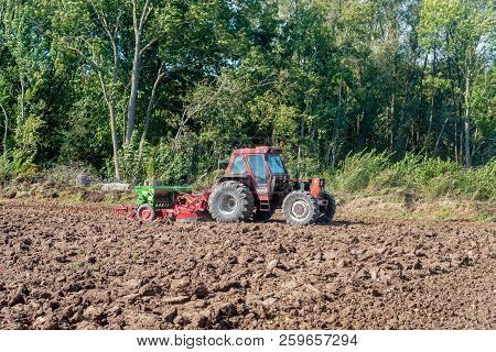 After Plowing The Field The Peasant Makes The Field Ready For Sowing. The Green Colored Cultivator A