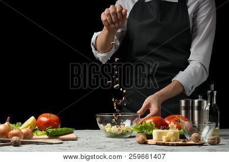 Freezer Food Prepare In Process Vegetarian Salad By Chef Hand In Home Kitchen. Dark Black Background