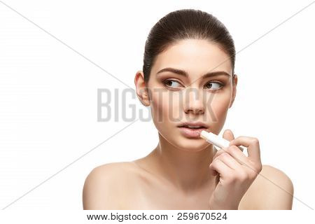 Girl Applying Pink Lipstick Isolated On White