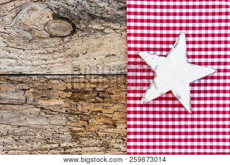 Wooden Christmas Star On Red Checkered Fabric And Old Wood, Copy Space