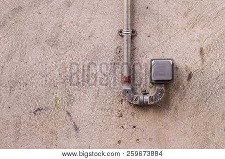 Weatherproof Single Power Plug Socket Isolated Outdoor With Concrete Wall In Background