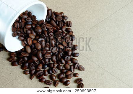 Coffee Beans Are Poured Out Of White Cup
