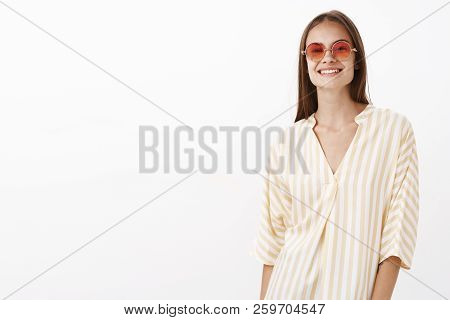Charming Girl Enjoying Lwarm Sunny Day Walking Along Beach In Trendy Yellow Striped Blouse And Sungl