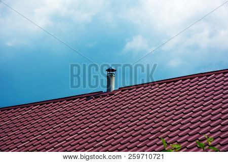 Chimney Tube Of Asbestos-cement On The Tileroof Of The House. Air Vent System On The Top