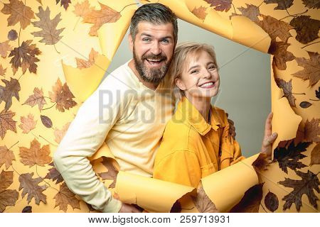 Romantic Couple Wearing Pullover On Autumn Leaves Background. Beautiful Tender Couple Advertise Your