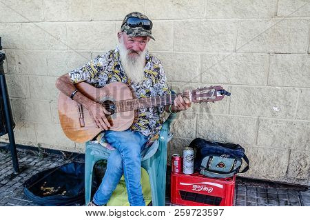 Torrevieja, Spain - Sept. 23 2018 :  Merlin Busking With Guitar Outside Carrefour Store