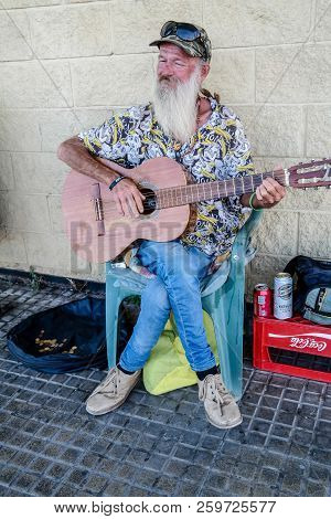 Torrevieja, Spain - Sept. 23 2018 :  Merlin Busking With Guitar Outside Carrefour Store