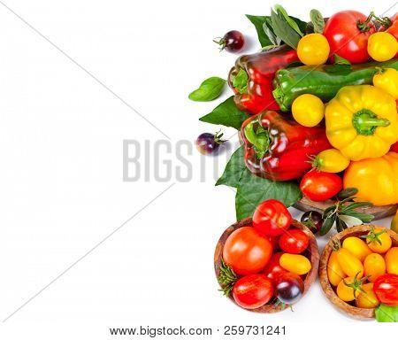 Assorted tomatoes and vegetables isolated on white background. Photo for your design.