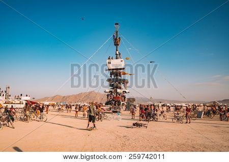 Guatemala - July 30, 2018. People Climbing Up The Huge Art Car Installation In The Middle Of A Deser