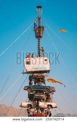 Guatemala - July 30, 2018. People Climbing Up The Huge Art Car Installation In The Middle Of A Deser