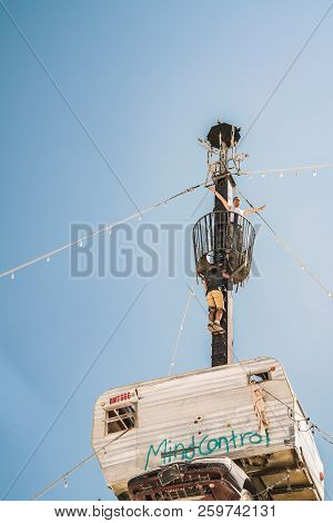 Guatemala - July 30, 2018. People Climbing Up The Huge Art Car Installation In The Middle Of A Deser