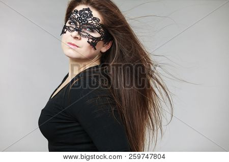 Pretty Mysterious Woman Wearing Black Eye Lace Mask Having Tousled Windblown Long Brown Hair.